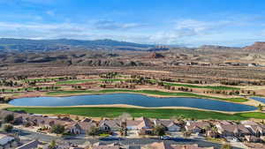 Aerial perspective of suburban area featuring a water and mountain view and a golf course