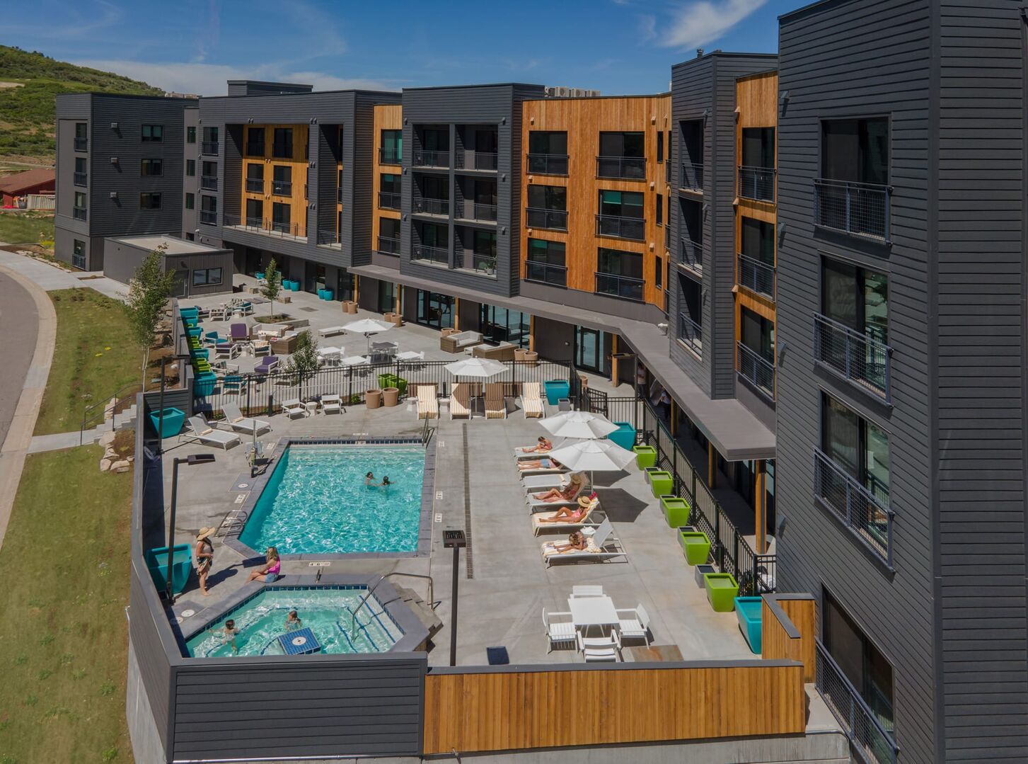 Community pool featuring a community hot tub and a patio