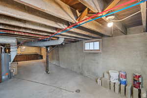 Below grade area featuring water heater