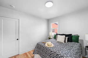 Bedroom with light wood-style floors and baseboards