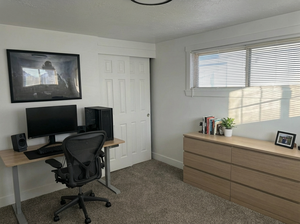 Office featuring a textured ceiling and dark carpet