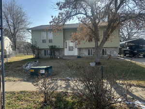 Split foyer home with stone siding