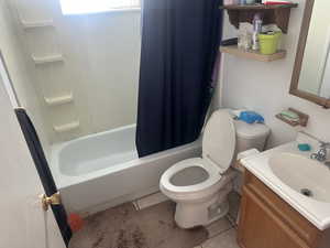 Bathroom featuring vanity, light tile patterned flooring, and shower / bath combo with shower curtain