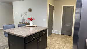 Kitchen with a center island and dark cabinets