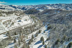 Snowy aerial view featuring a mountain view