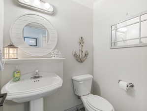 Half bath with ornamental molding and toilet