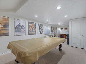 Rec room featuring light colored carpet, a textured ceiling, billiards table, and recessed lighting