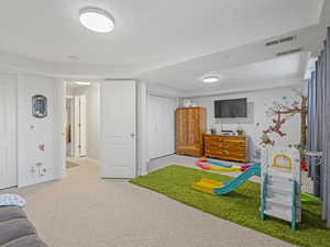 Recreation room featuring carpet floors and baseboards