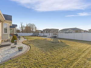 Fenced backyard featuring a patio, a pergola, and a residential view