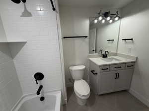 Bathroom featuring vanity, shower / tub combination, and light tile patterned flooring