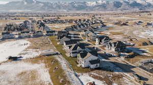 Snowy aerial view with a mountain view and a residential view