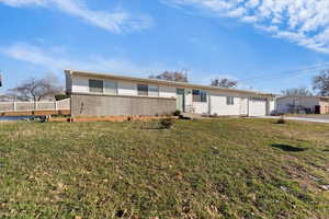 Ranch-style house with brick siding and a front yard