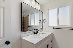 Bathroom with a tile shower and vanity