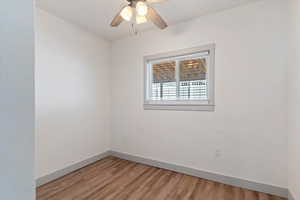 Empty room featuring wood finished floors and ceiling fan