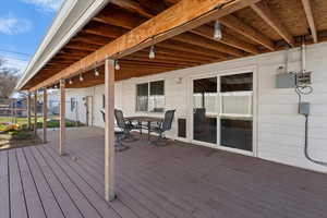 Wooden terrace featuring outdoor dining area
