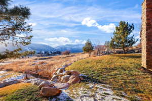 View of grassy yard featuring a mountain view and a rural view