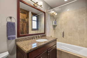 Full bath featuring vanity and tiled shower / bath combo