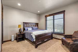 Bedroom featuring light colored carpet and recessed lighting