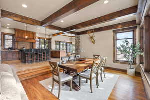 Dining space featuring recessed lighting, light wood-type flooring, and beam ceiling