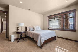 Bedroom featuring light colored carpet and recessed lighting