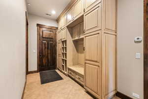 Mudroom with light tile patterned floors and recessed lighting