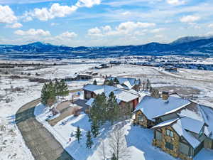 Snowy aerial view featuring a mountain view