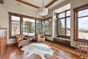 Sunroom featuring healthy amount of natural light, hardwood / wood-style flooring, and recessed lighting