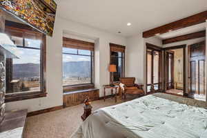 Bedroom with carpet, recessed lighting, and beam ceiling