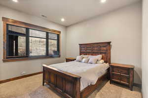 Bedroom featuring light colored carpet and recessed lighting