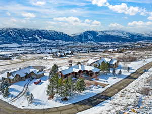 Snowy aerial view featuring a mountain view