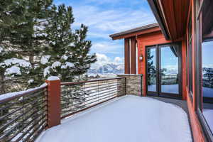 Snow covered back of property featuring a mountain view