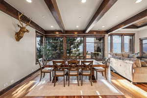 Dining area featuring recessed lighting, light wood-style flooring, and beam ceiling