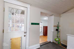 Entryway featuring tile patterned flooring and vaulted ceiling