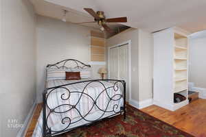 Bedroom with wood finished floors, a closet, and ceiling fan