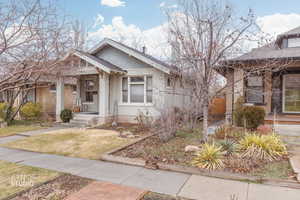 Bungalow-style house featuring a shingled roof and brick siding