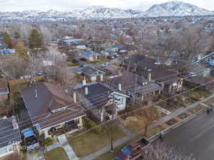 Aerial view of property's location featuring nearby suburban area and mountains