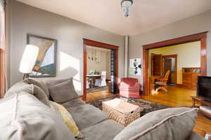 Living room featuring wood finished floors and a chandelier