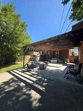 Fenced backyard featuring a pergola, an outdoor hangout area, and a patio