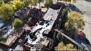 Aerial view of property's location featuring nearby suburban area