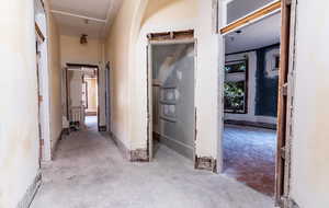 Corridor featuring unfinished concrete flooring