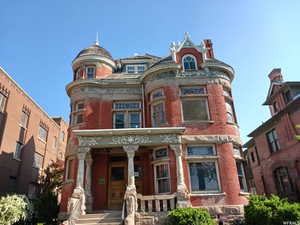 Victorian home with a porch and brick siding