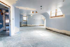 Unfurnished room featuring radiator