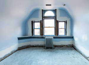 Additional living space with radiator and lofted ceiling