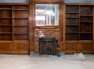Unfurnished living room with a fireplace with flush hearth