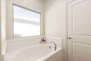 Full bathroom featuring a bath