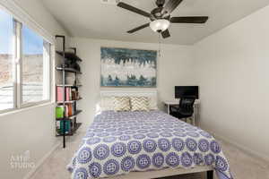Bedroom with light colored carpet and ceiling fan