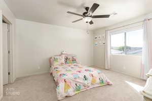 Bedroom with light carpet and ceiling fan