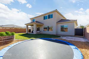 Back of property featuring a patio area, a fenced backyard, stucco siding, and a tiled roof