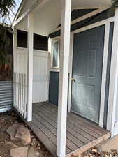 Entrance to property with board and batten siding and a porch