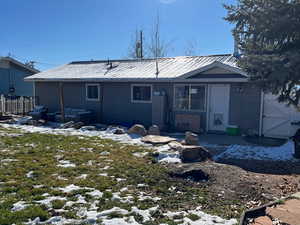 Snow covered house with a gate